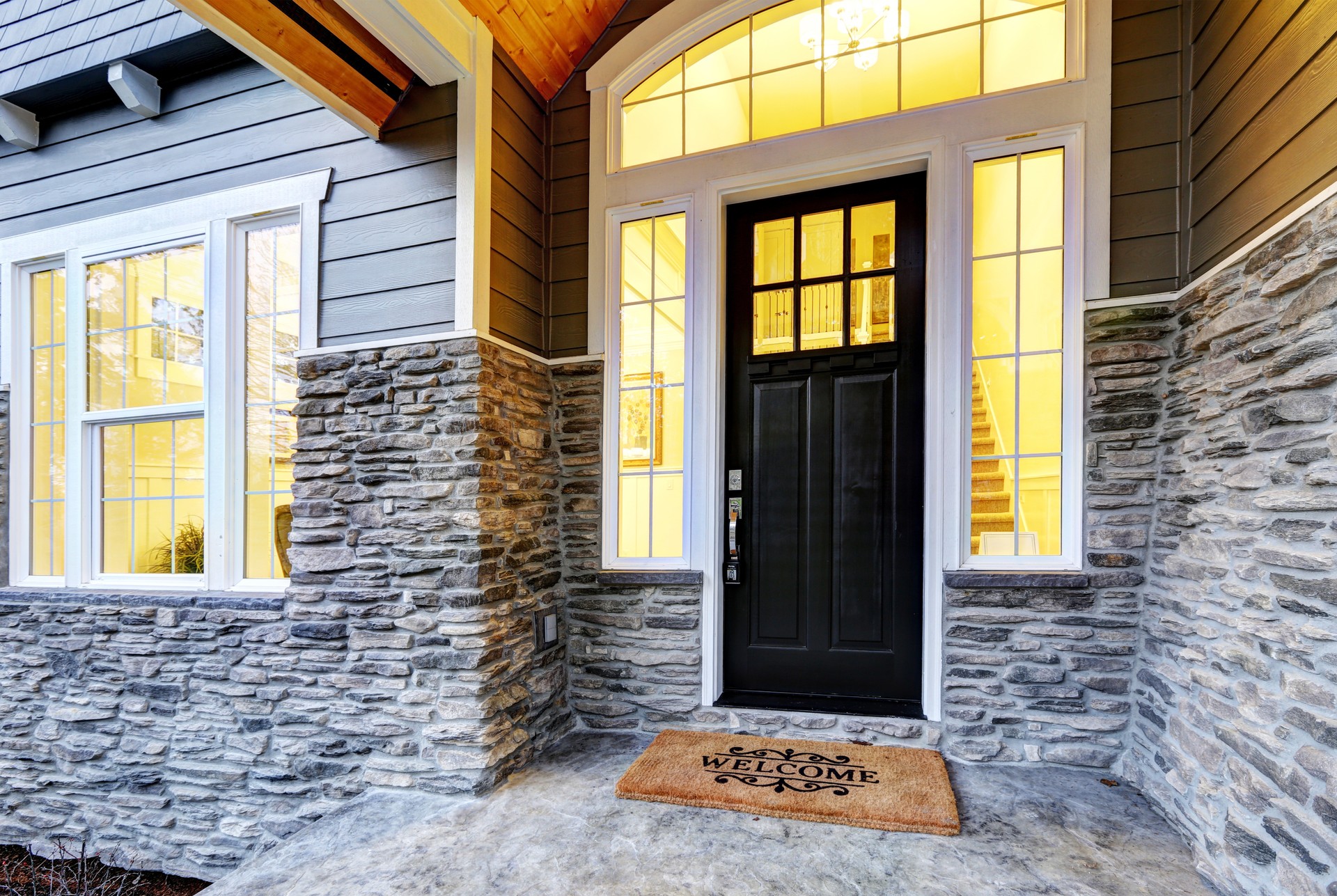 Front covered porch design with stone columns